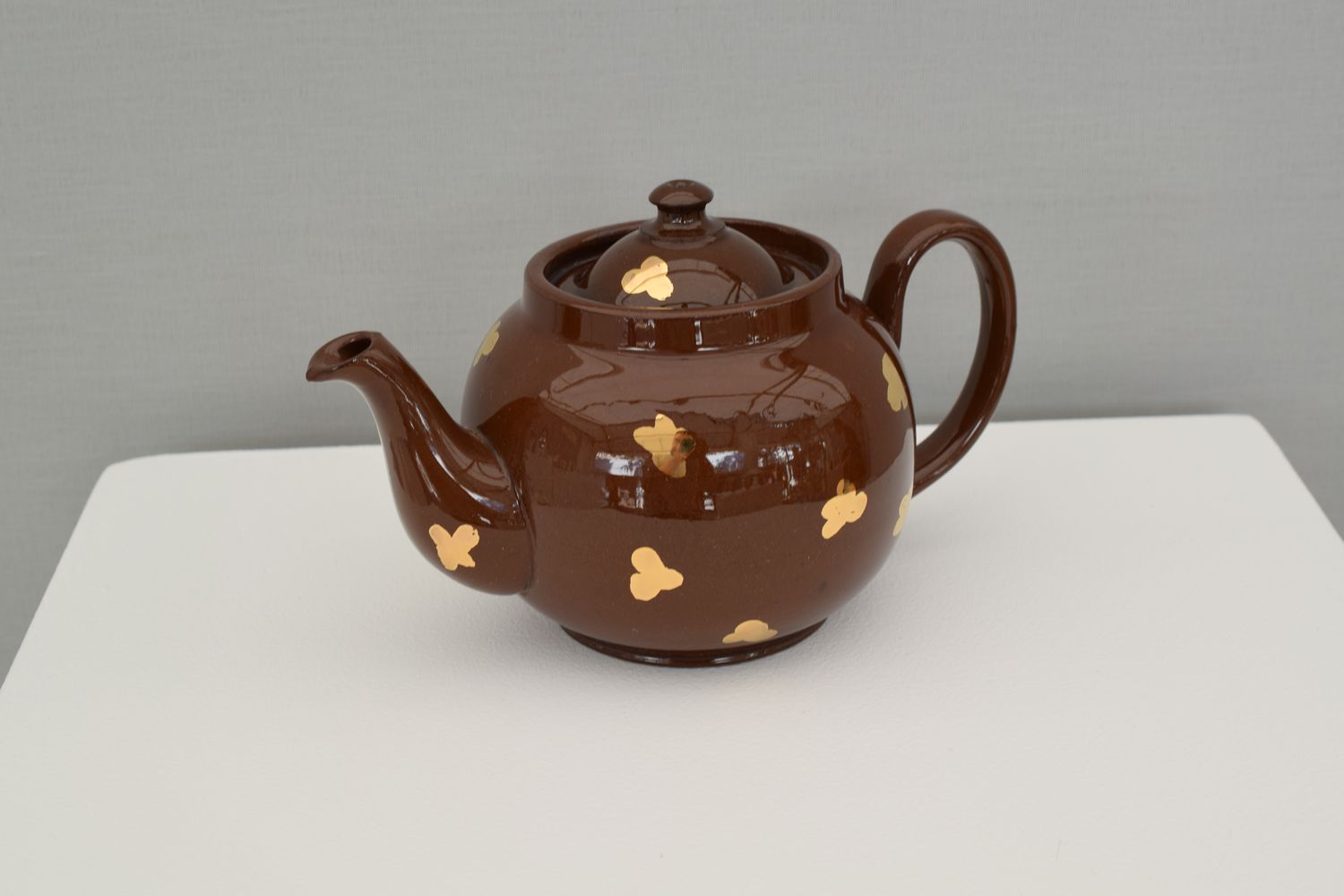 Théière marron avec fleurettes dorées